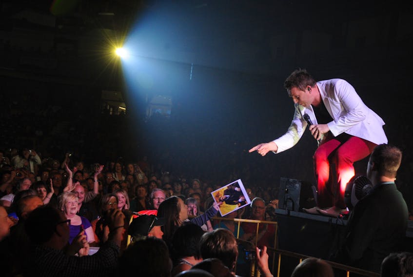 Country music crooner Johnny Reid interacts with a fan during one of his stop at the Corner Brook Civic Centre in 2012.