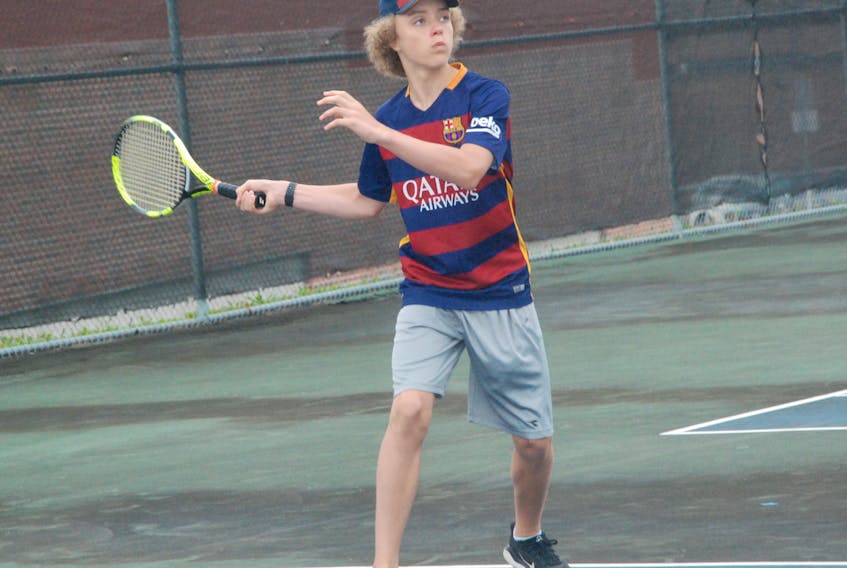 Isaac Buckingham gets set to return the ball during an exchange with Colin Spencer during the U14 boys singles final at the 2018 Corner Book Junior Open Tennis Tournament Thursday at the Wellington Street tennis courts. Buckingham also won top honours in the 16U male division, earning the 16U singles title with a victory over his older sibling Matthew Buckingham.