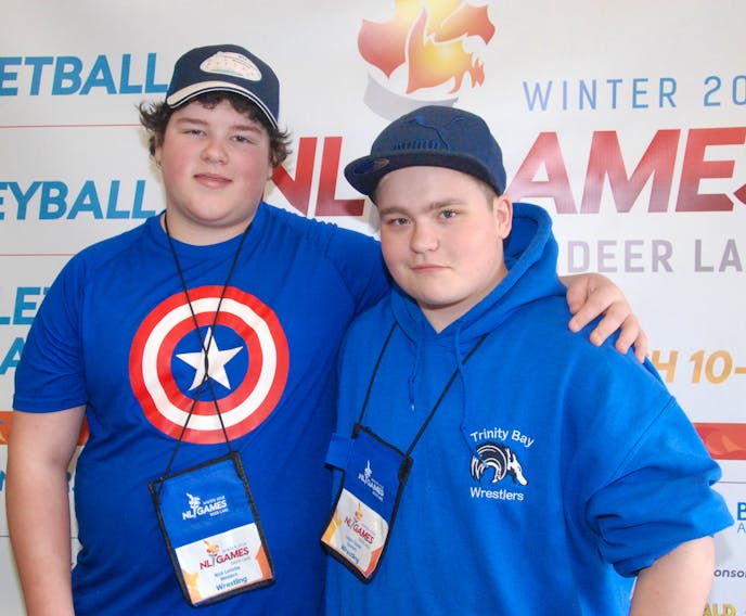 Nicholas LeRiche, left, of Port aux Basques, poses for a photo with fellow Games wrestler Logan Drover of Eastern at the Athletes Village Friday afternoon.