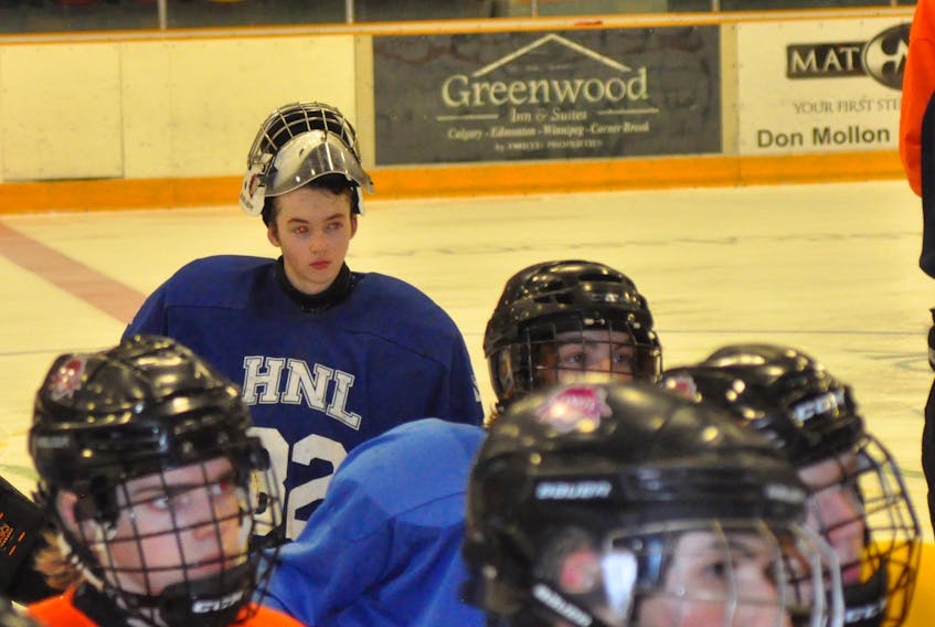 Goaltender Kirklin Young (in far back) listens to the coaches during a break in the action during a Dennis GM Western Kings practice Wednesday night at the Corner Brook Civic Centre.