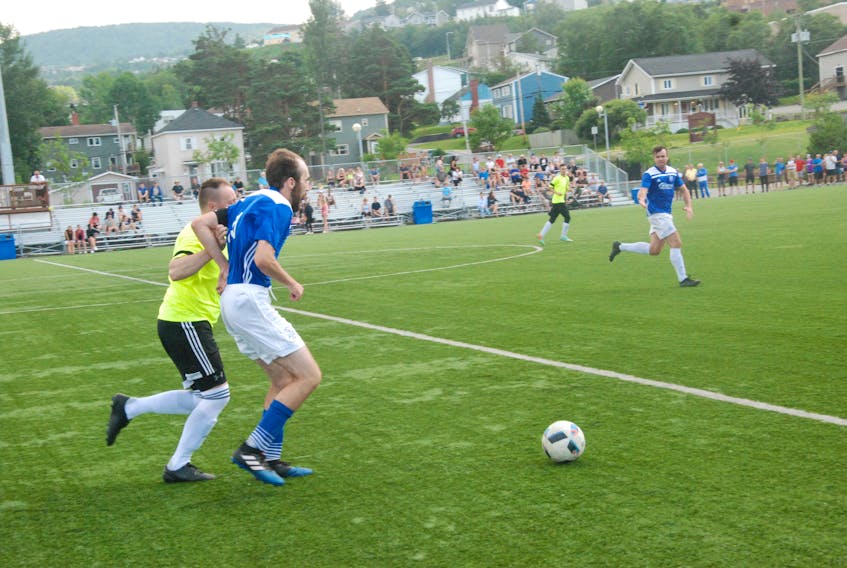 Pat Fewer of the West Side Monarchs chases down Greg Myrden of the Northridge Curling Rangers during the Corner Brook senior men's soccer league final Saturday. Ryan Dawe scored two goals to lead the Monarchs to a 3-1 victory.