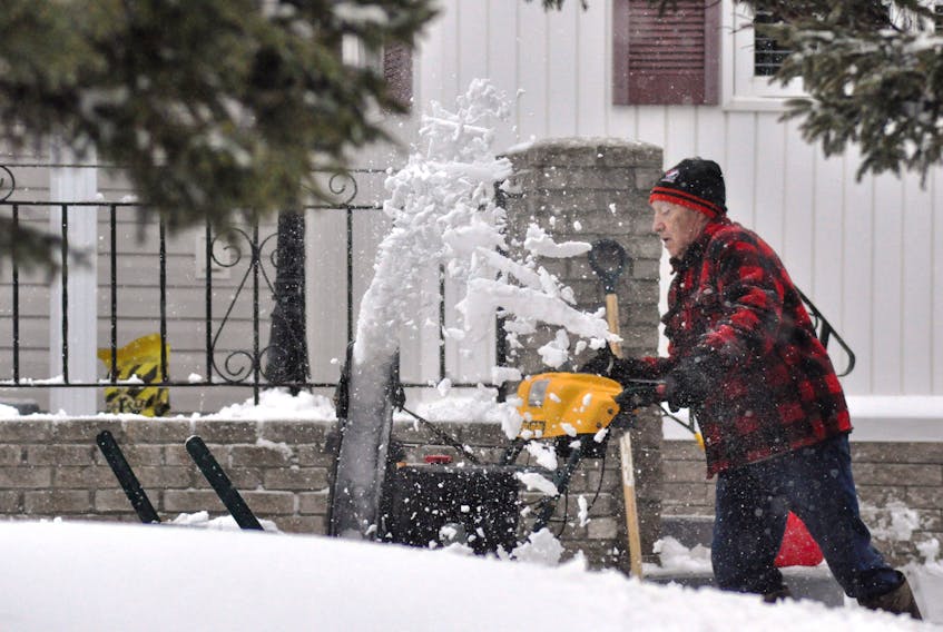 Terry White, whose driveway is located at the corner of Crown Avenue and Kelly Place in Stephenville, was busy this morning blowing snow after an overnight dumping before turning mild for a short while.