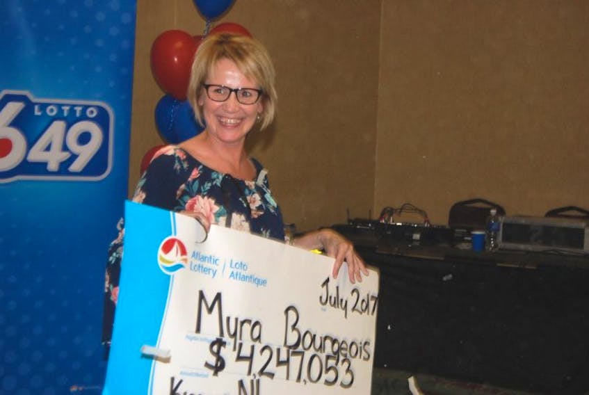 Myra Bourgeois of Kippens poses for a photo with her ceremonial $4.2 million lottery cheque from Atlantic Lottery Corporation.
