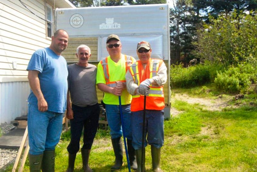 The search continues for Larry Young of St. George’s. Posing for a photo are searchers: Bobby White and Randy Sheppard of Flat Bay; Richard Legge of Shallop Cove; and Raymond Young, Larry’s brother.