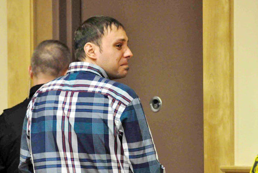 Nicholas Shears-Decker looks toward his family as he leaves the Corner Brook courtroom Thursday.