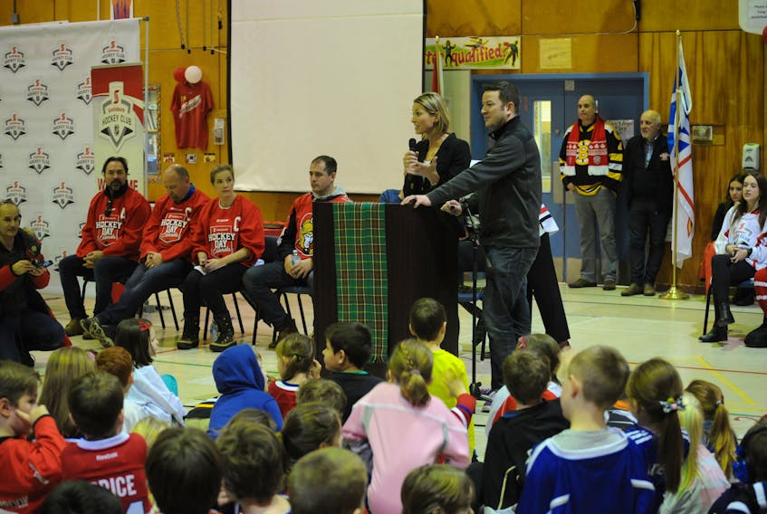 Sportsnet broadcasters Evanka Osmak and Ken Reid, at podium, and some famous hockey players visited C.C. Loughlin Elementary School in Corner Brook with the Stanley Cup Thursday morning.