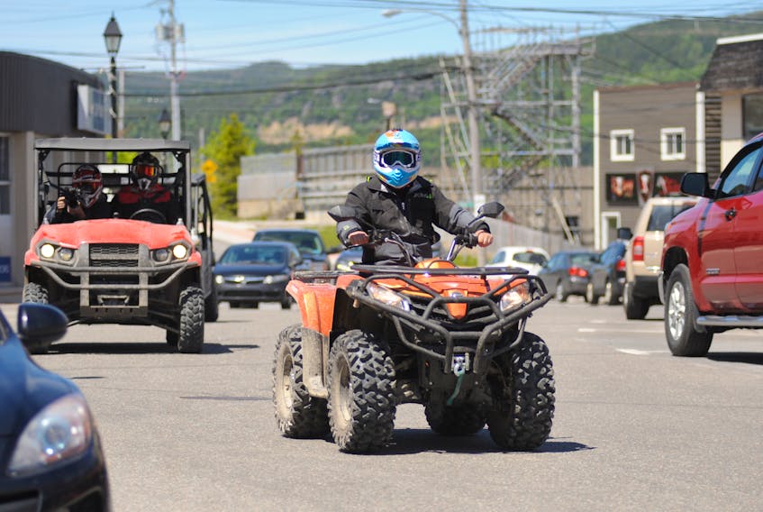 The film crew of DirtTrax television make their way down Broadway in Corner Brook Thursday afternoon.