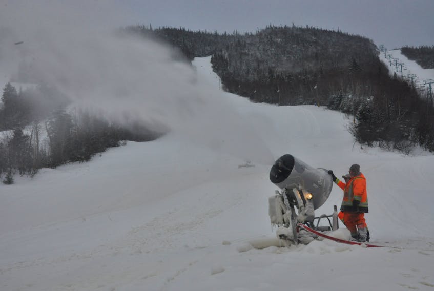 A crew operates a snow gun at Marble Mountain last week. The resort's opening day has been pushed back from Wednesday to Saturday.