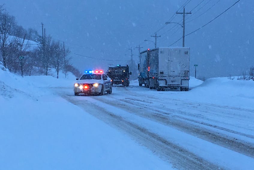 A police car heads to temporarily shut down a section of the Lewin Parkway in Corner Brook where two tractor trailers were stuck on an icy hill Wednesday morning.