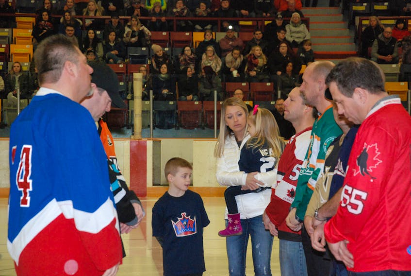 Joy Green, with son Ryan and daughter Lexi, celebrate the life of her fiancé Mr. Shawn Neary during a jersey retirement ceremony for No. 24 at the Corner Brook Royals game Friday night at the Civic Centre . Some of Neary’s teammates from various sports teams shared in the ceremony by wearing some of the jerseys Neary adorned during his sports life before his shocking death in 2016.