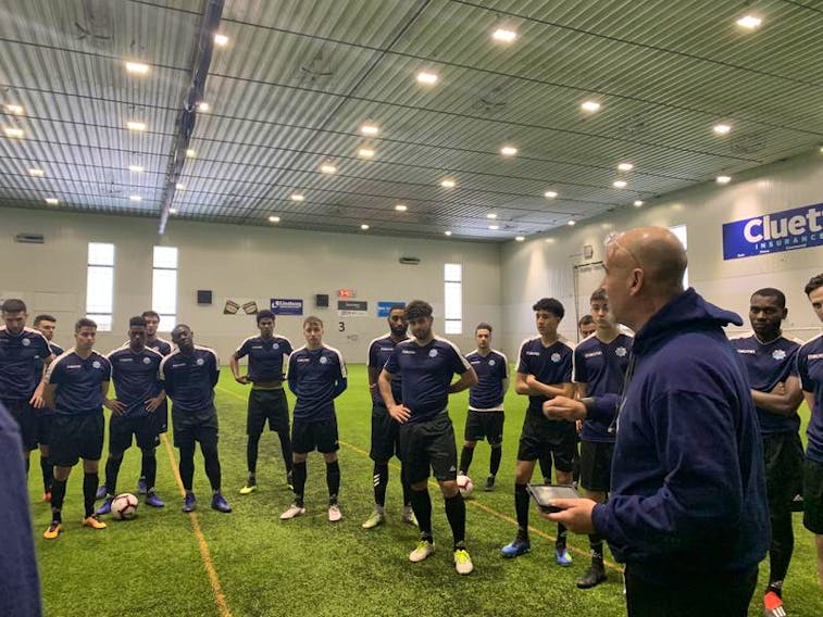 Coach Stephen Hart, right, talks to the players at the HFX Wanderers FC training camp at Soccer Nova Scotia.