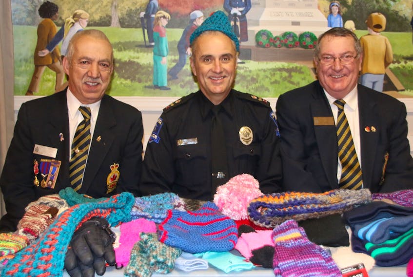 Members and guest of the Truro Legion recently presented the Truro Police Service with warm accessories that can be handed out to anyone they see in need. Taking part in the presentation were, from left, Truro Legion President Grant O’Laney, Deputy-Chief Jim Flemming – modelling one of the hats – and Truro Legion 1st Vice President Ross Moore.