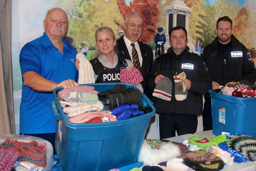 The Truro branch of the Royal Canadian Legion handed some warm donations over to local police forces, who will distribute them throughout the community. Taking part in the presentation were, from left, Gerry Tucker, Legion past president’ Cst. Lorilee Morash, of the Colchester District RCMP, Grant O’Laney, immediate past president of the Legion, Truro Police Inspector Rob Hearn and Truro Police Sgt. Robert Hunka.