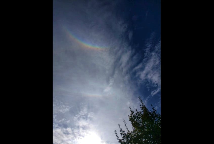 Sun dogs appear low on the horizon. To see a circumzenithal arc, you have to look up ... way up! Jess Bargen spotted this one in the sky over Kentville Nova Scotia last week.