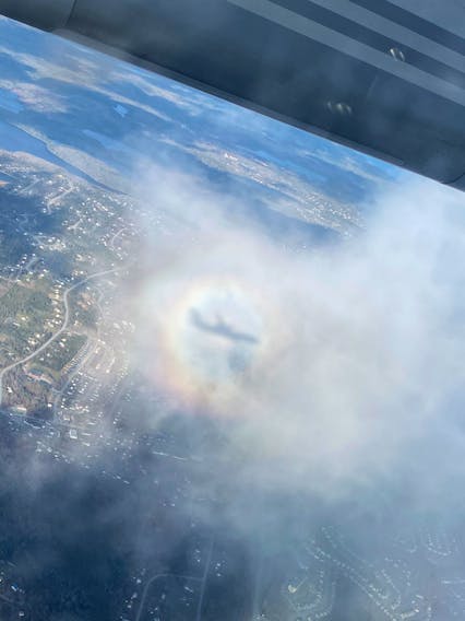 Julia Thomson of Ottawa took this amazing photo last month on her descent to the Stanfield International Airport in Halifax. Her family suggested she send this in, with hopes that I could explain the colourful ring around the plane’s shadow.