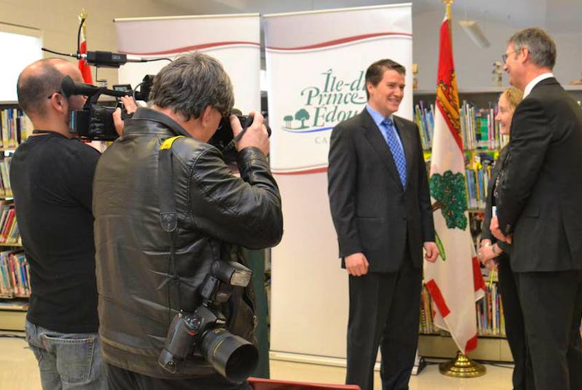 Provincial photographer Brian Simpson and videographer John Ross Fitzpatrick capture images of Education Minister Jordan Brown and Public Schools Branch director Parker Grimmer at a recent funding announcement. 
(Teresa Wright/The Guardian)
