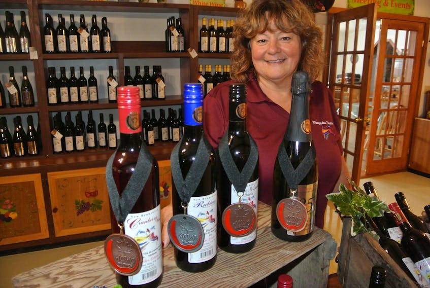 Winegarden Estates president and CEO Elke Muessle shows off some of her company’s award-winning wines from the 38th All Canadian Wine Championships. Its blueberry wine won silver while its cranberry wine, sparkling wine and house blend Victor McLaughlin each won bronze.