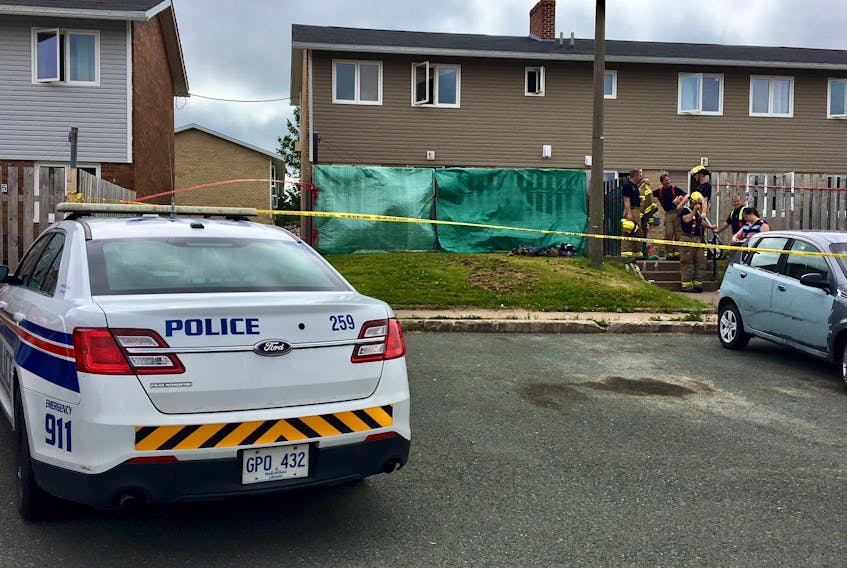 Tarps surround the house on Cowperthwaite Court in St. John's, where the body of a woman was found this afternoon. — Photo by Rosie Mullaley/The Telegram