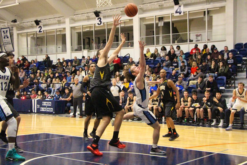 St. F.X. X-Men guard Thomas Legallais attempting a contested layup during a game at the Oland Centre last month, versus the Dalhousie Tigers.