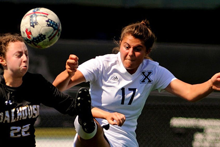 St. F.X. X-Women first-year player Hannah Engdahl battles her Dalhousie Tigers’ opponent during pre-season action on the turf at the Chedabucto Lifestyle Complex in Guysborough. Bryan Kennedy