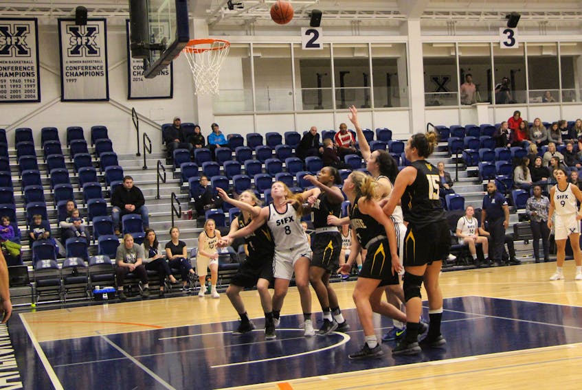 St. F.X. X-Women Kimberley Kingsbury (#8) and Brianna Gottschall position themselves for a possible offensive rebound in a game last month at the Oland Centre, versus the Dalhousie Tigers.