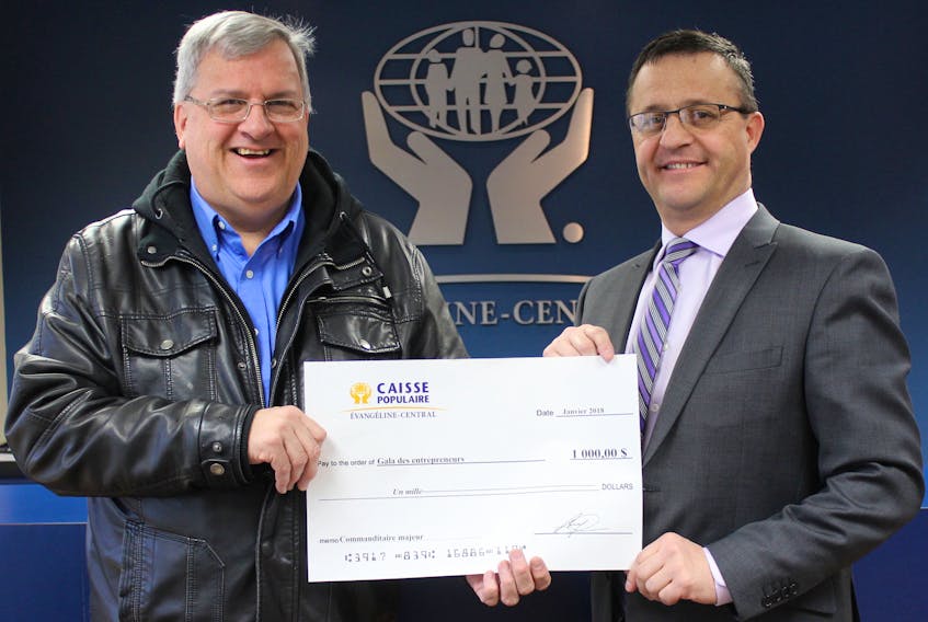 Acadian Entrepreneurs' Gala co-ordinator Raymond J. Arsenault, left, accepting a major sponsorship cheque from Alfred Arsenault, general manager of Evangeline-Central Credit Union.