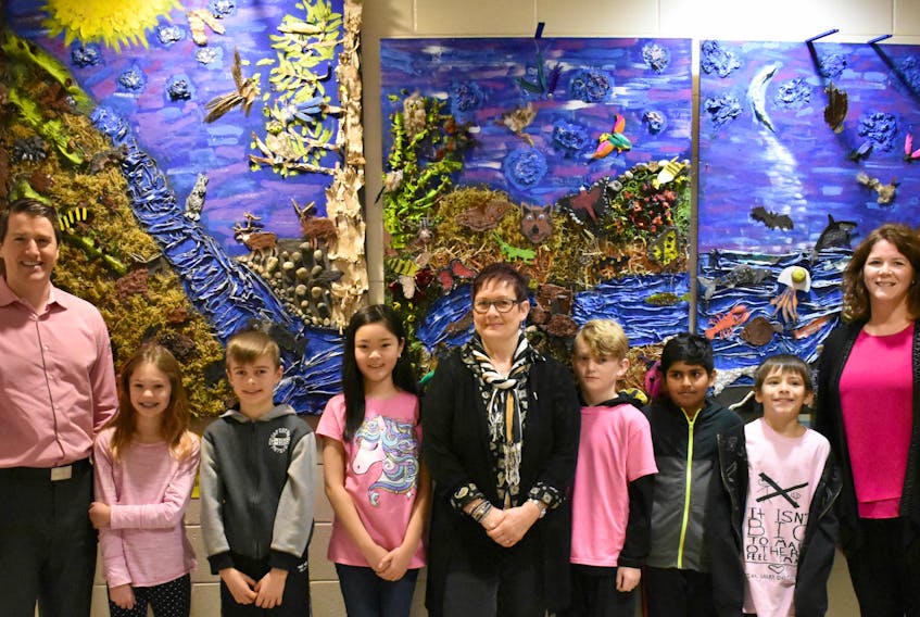 Minister Jordan Brown, left, with artist Dina Blot and West Royalty Elementary teacher Tracey Smith and students.