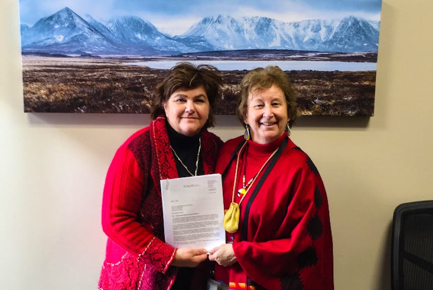 Chief Mildred Lavers (right) delivers a copy of the Mekap’sk Mi’kmaq Band's title assertion to Long Range Mountains MP Gudie Hutchings. - Mekap'sk Mi'kmaq Band