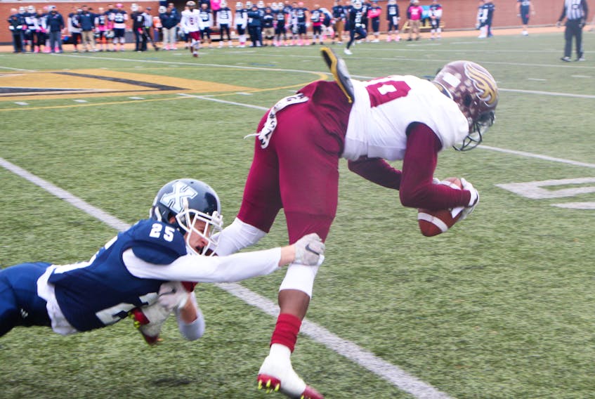 - St. F.X. X-Men defensive back Ethan Mastin makes a nice lounging tackle on a Mount Allison Mountie receiver, during the X-Men’s final regular season game, played Oct. 27 at Oland Stadium. Richard MacKenzie