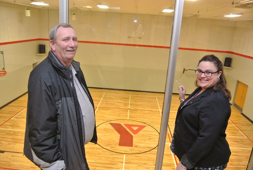 Cumberland YMCA chairman of the board Charles Seymour and CEO Trina Clarke look over the new gym floor at the Amherst facility.