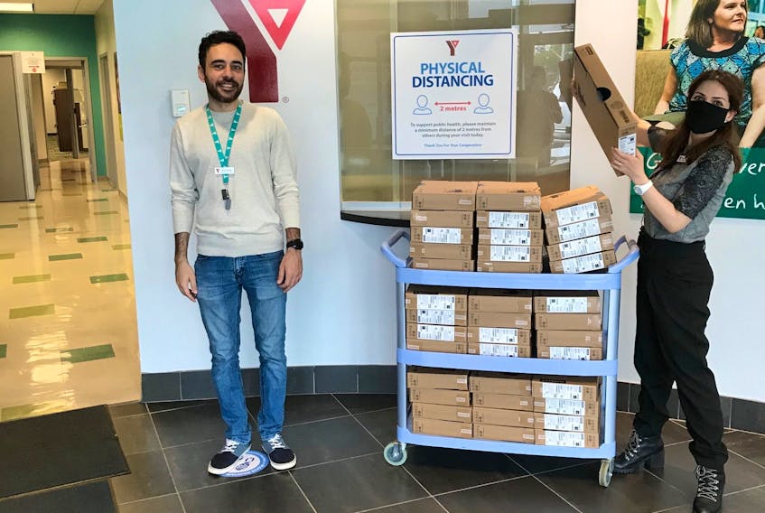 Ala Sadie and Maha El Tabcheh of the YMCA Centre for Immigrant Programs helping with the distribution of free laptops to newcomer families in the Halifax Regional Municipality. By Tuesday, the Y will have distributed 279 laptops to 250 families.