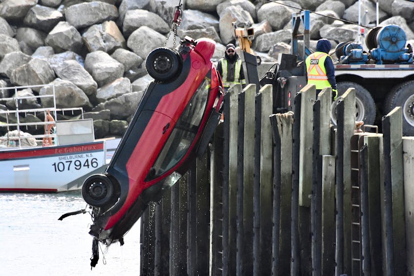 A vehicle is lifted out of the water at the Cape St. Mary's wharf in Digby County the morning of Sunday, March 1. On Facebook a video was posted of someone purposely crashing the vehicle through the wooden piles, sending the vehicle into the water. A person emerges safely from the vehicle after it submerges. TINA COMEAU PHOTO