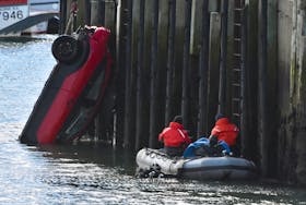 A vehicle is hoisted from the Cape St. Mary's wharf in southwestern Nova Scotia on Sunday, March 1, after it was sent plunging into the water in an apparent prank. A video was posted on Facebook. TINA COMEAU PHOTO