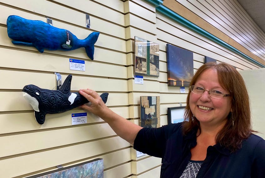 Judy Jenkins, president of the Yarmouth Art Society, with some of her work on display at the new home for the group – the Yarmouth Mall.