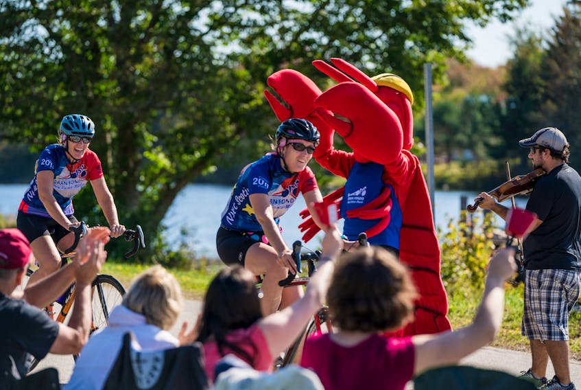 Spectators cheer on participants during the Gran Fondo Baie Sainte-Marie. Although the event is timed, the Gran Fondo is described as “more of a self-paced fun group event than a race.”