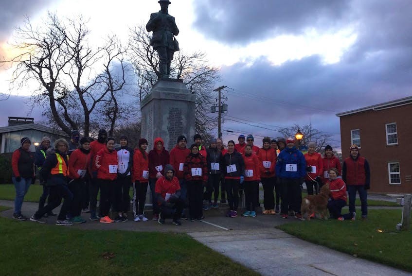 Participants in a past Poppy Run at the Yarmouth cenotaph, which serves as the start/finish for the event.