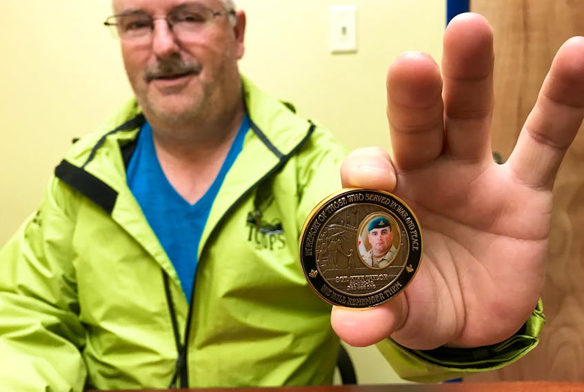 Capt. Gary Hudson, commanding officer of 110 Royal Canadian Army Cadet Corps in Yarmouth, holds the commemorative coin that bears an image of Sgt. Kirk Taylor, who was killed in Afghanistan a decade ago. The coin’s other side recognizes the 115th anniversary of the 110 army cadet corps.