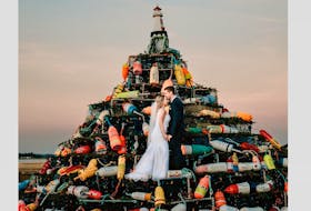 Abigail and James Ross stand in the Municipality of Barrington’s Lobster Pot Christmas Tree for one of their wedding photos. CARLY MACKAY PHOTOGRAPHY