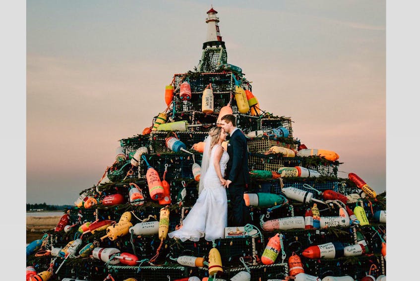 Abigail and James Ross stand in the Municipality of Barrington’s Lobster Pot Christmas Tree for one of their wedding photos. CARLY MACKAY PHOTOGRAPHY