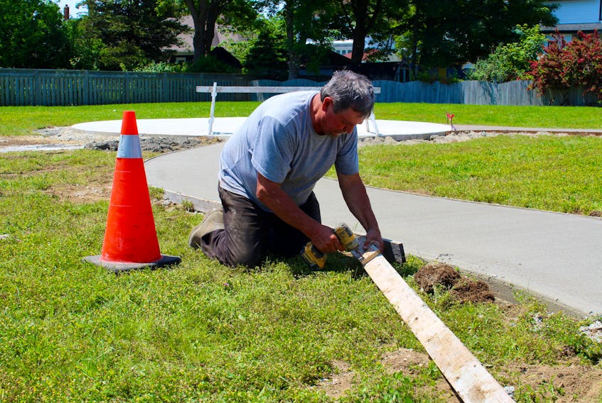 Allan Dugas of D's Decorative Concrete Ltd. working on Tuesday, July 9, at the Parade Street site in Yarmouth where a statue of Sara Corning will be located.