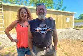Vic and Krista Penner stand outside their new home in Gilbert's Cove, Digby County, during the construction process. Around 560,000 recycled plastic bottles were used by the Meteghan, N.S. company JD Composites in the building material that makes up the shell of their house. TINA COMEAU PHOTO
