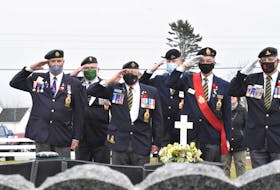 Members of Wedgeport Legion Branch 155 salute as Canadian flags are placed on the graves of veterans in a cemetery in Pinkney's Point, Yarmouth County, on Nov. 6. TINA COMEAU PHOTO