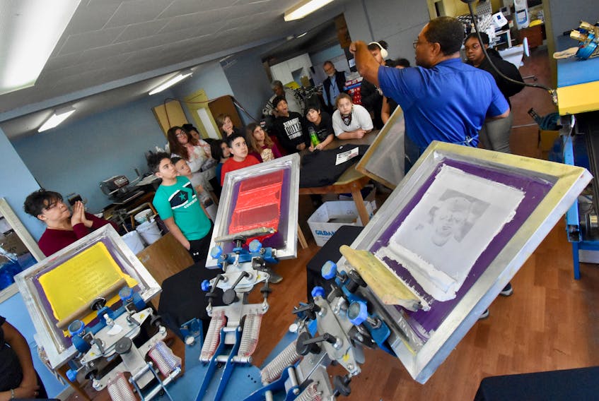 The screen printing process is set up to make the t-shirts that will include a photo of Yarmouth’s Bruce Johnson, who was Nova Scotia's first African Nova Scotian pharmacist. Let's Print It owner Sheridan Lawrence explains the process to visiting students from Yarmouth Elementary School. TINA COMEAU PHOTO
