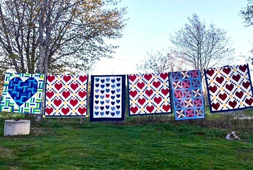 As the 430+ quilts arrived from across the nation over a nine-week period , the president of the Maritime Modern Quilt Guild hung them in groups on her clothesline to let quilters know their contribution had arrived safely.