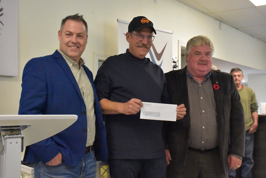 Lobster bait challenge winner Vince Stuart receives $30,000 prize at announcement at Ignite Labs in Yarmouth, presented by Ignite Labs CAO Doug Jones and Jeff Mullen of ACOA. TINA COMEAU PHOTO