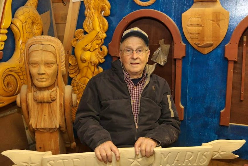 The late Jean Belliveau with ornate wood carvings he made for his 36-foot long replica of a Dutch sailing yacht - Stella Maris. 
Karla Kelly File Photo