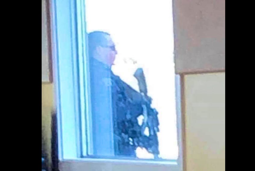 An RCMP officer stands outside of the Rotary Centre Community Hall at the Hebron Recreation Complex in Yarmouth County on Feb. 19 as a search was underway for a suspect following a vehicle theft. It was not known if the suspect was armed. A Yarmouth Recreation after-school program was happening inside the building. Yarmouth Recreation director Frank Grant says the RCMP went 'over and above' to ensure those inside the building felt safe and protected. CONTRIBUTED PHOTO