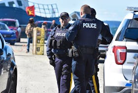 Members of the RCMP at the Saulnierville wharf on Saturday, Sept. 19. Sipekne’katik First Nation is exercising its Treaty right and conducting its own  moderate livelihood fishery from here that the commercial season calls unauthorized. The band had access to the wharf blocked off on the weekend to only its fishers and supporters. TINA COMEAU PHOTO