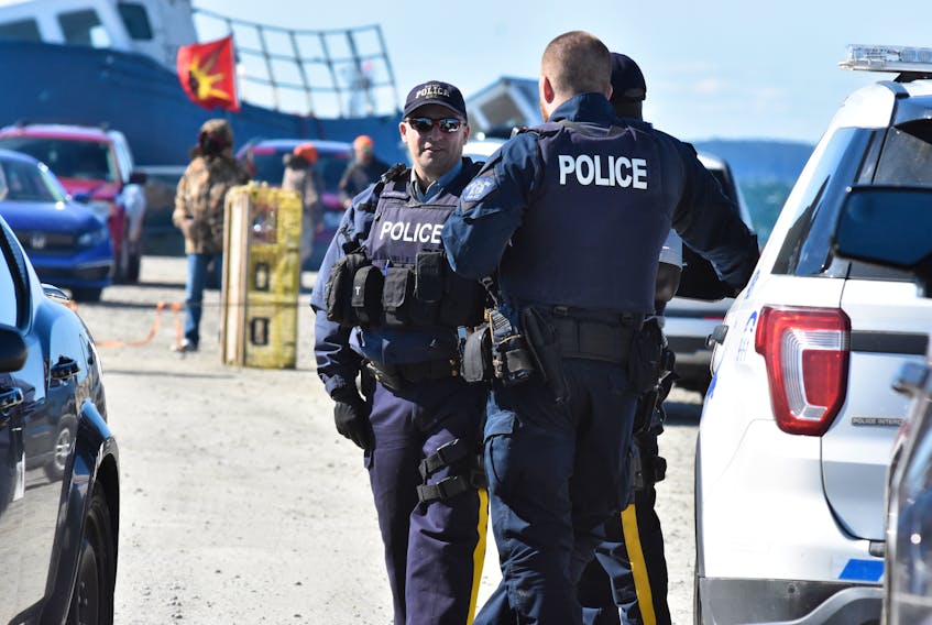 Members of the RCMP at the Saulnierville wharf on Saturday, Sept. 19. Sipekne’katik First Nation is exercising its Treaty right and conducting its own  moderate livelihood fishery from here that the commercial season calls unauthorized. The band had access to the wharf blocked off on the weekend to only its fishers and supporters. TINA COMEAU PHOTO