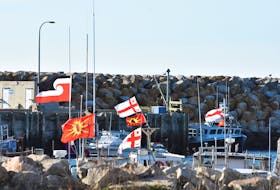 Flags flap in the wind from Sipekne’katik First Nation boats tied up at the Saulnierville wharf. TINA COMEAU PHOTO